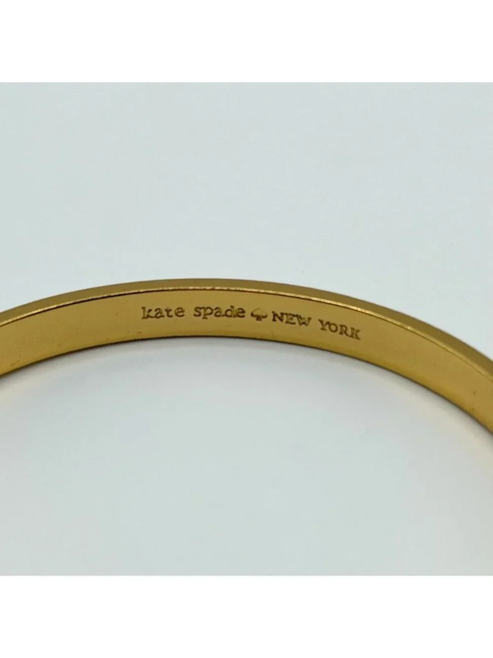 Kate Spade New York Cream Enamel Bow Gold-Tone Bangle Bracelet - Picture 3 of 4